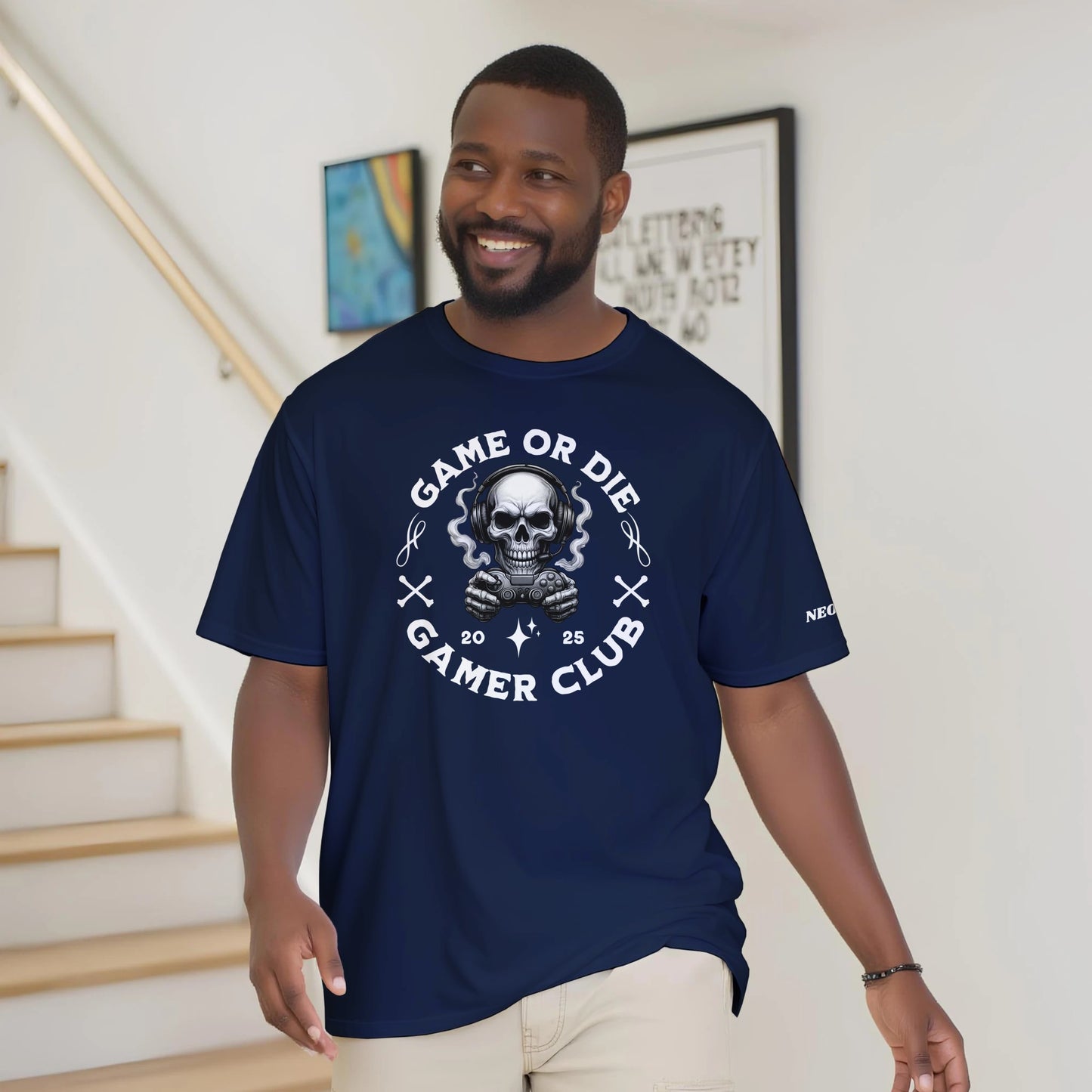 Man wearing a navy blue t-shirt with a skull graphic and text, standing indoors.