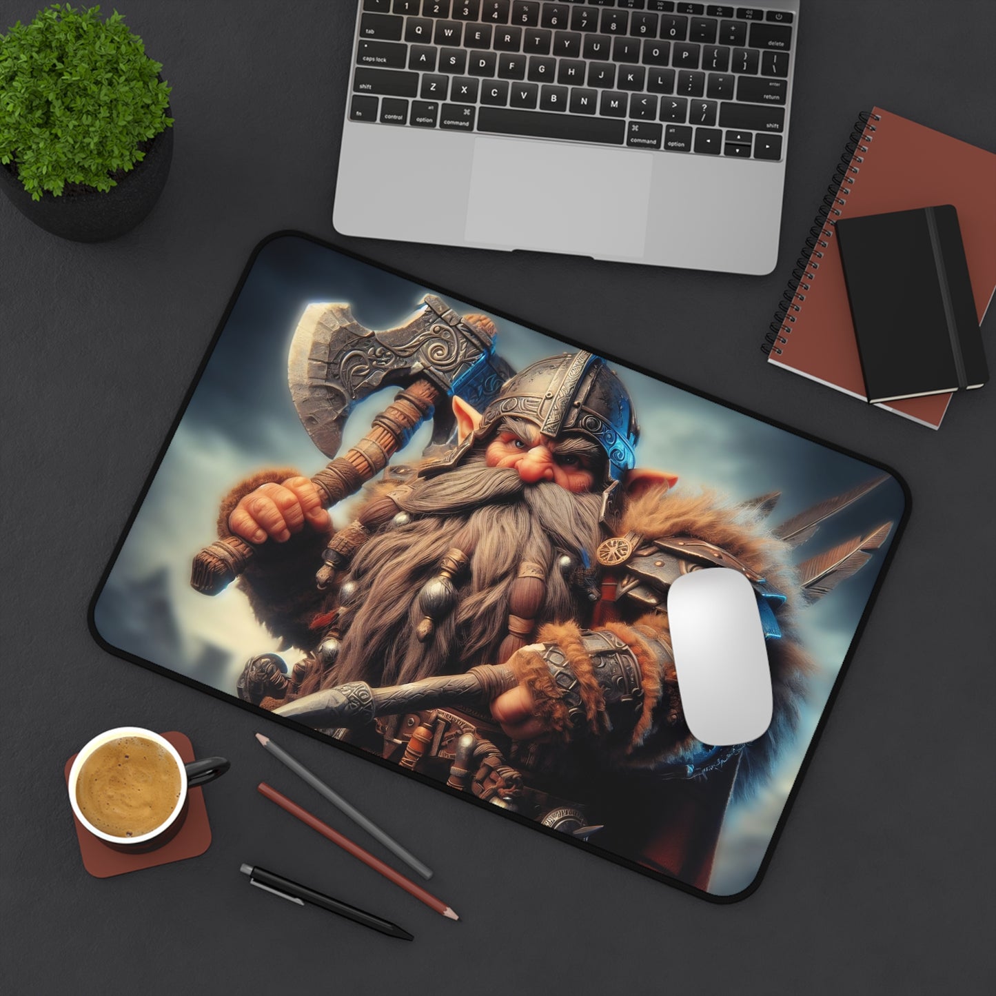 Gnome warrior mouse pad on a desk with laptop, notebook, and coffee cup.