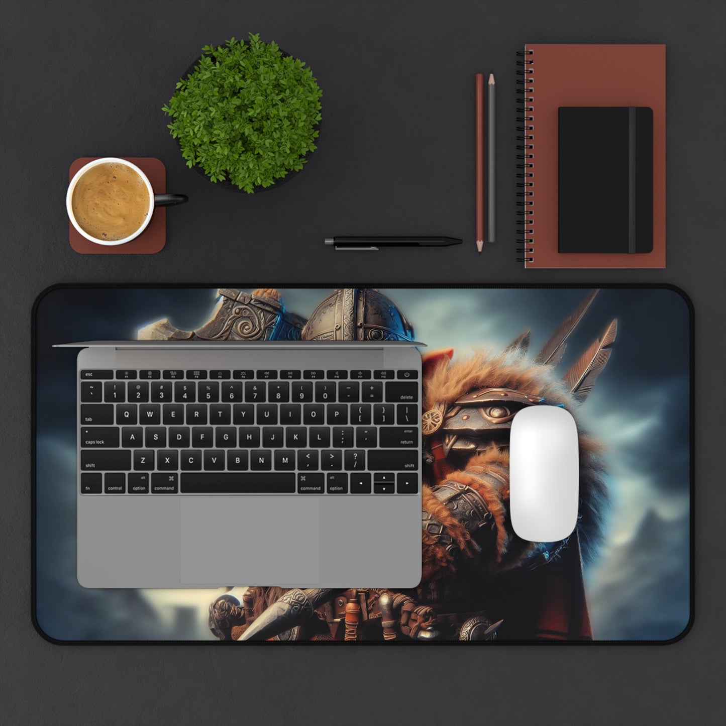 Desk setup with a laptop, mouse, and decor items on a dark surface