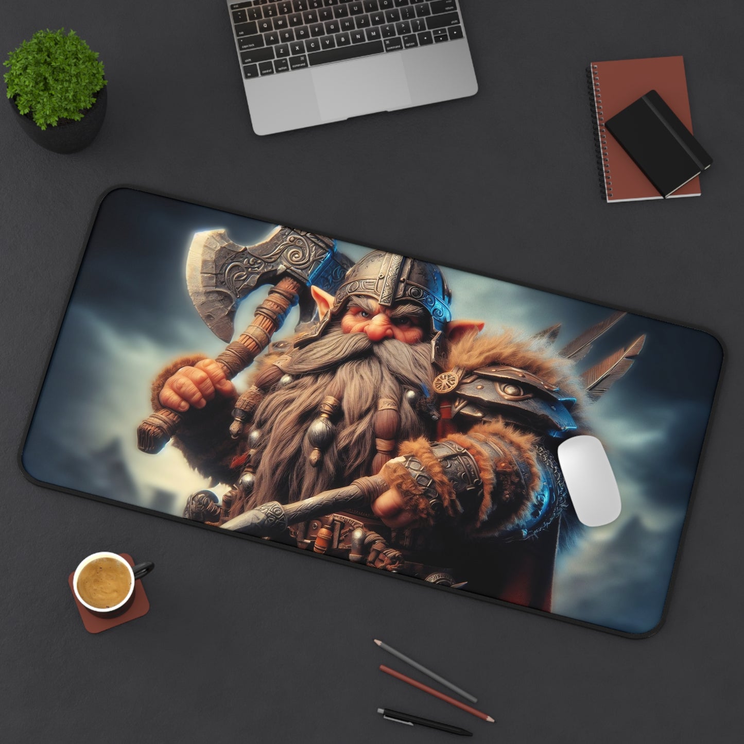 Gnome warrior with an axe on a large mouse pad, surrounded by a laptop, notebook, and coffee cup on a dark surface.