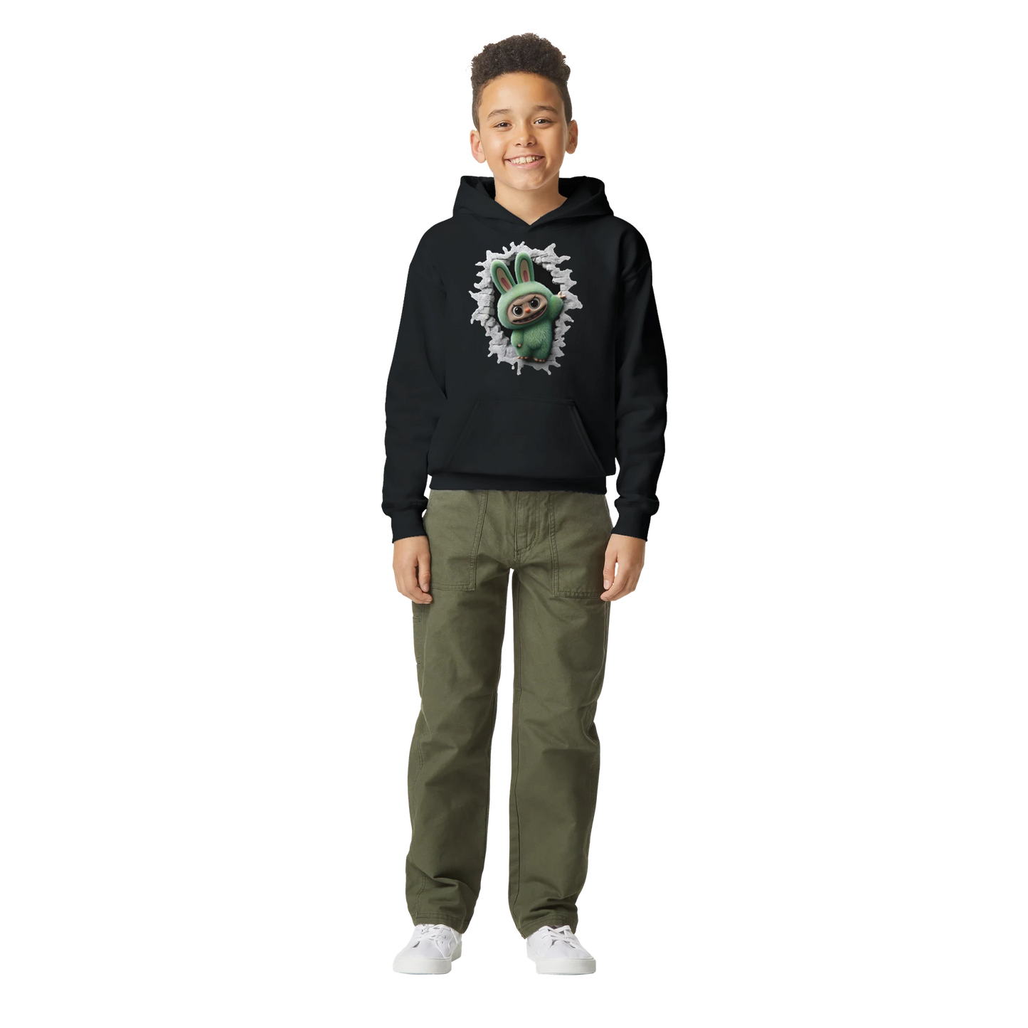 Child wearing a black hoodie with a graphic design of labubu monster and green pants on a white background
