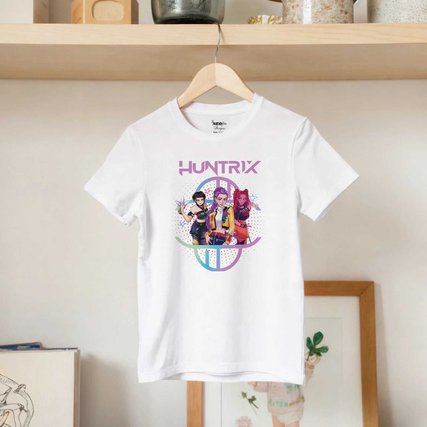 White t-shirt with 'HUNTRIX' graphic design on a hanger against a neutral background