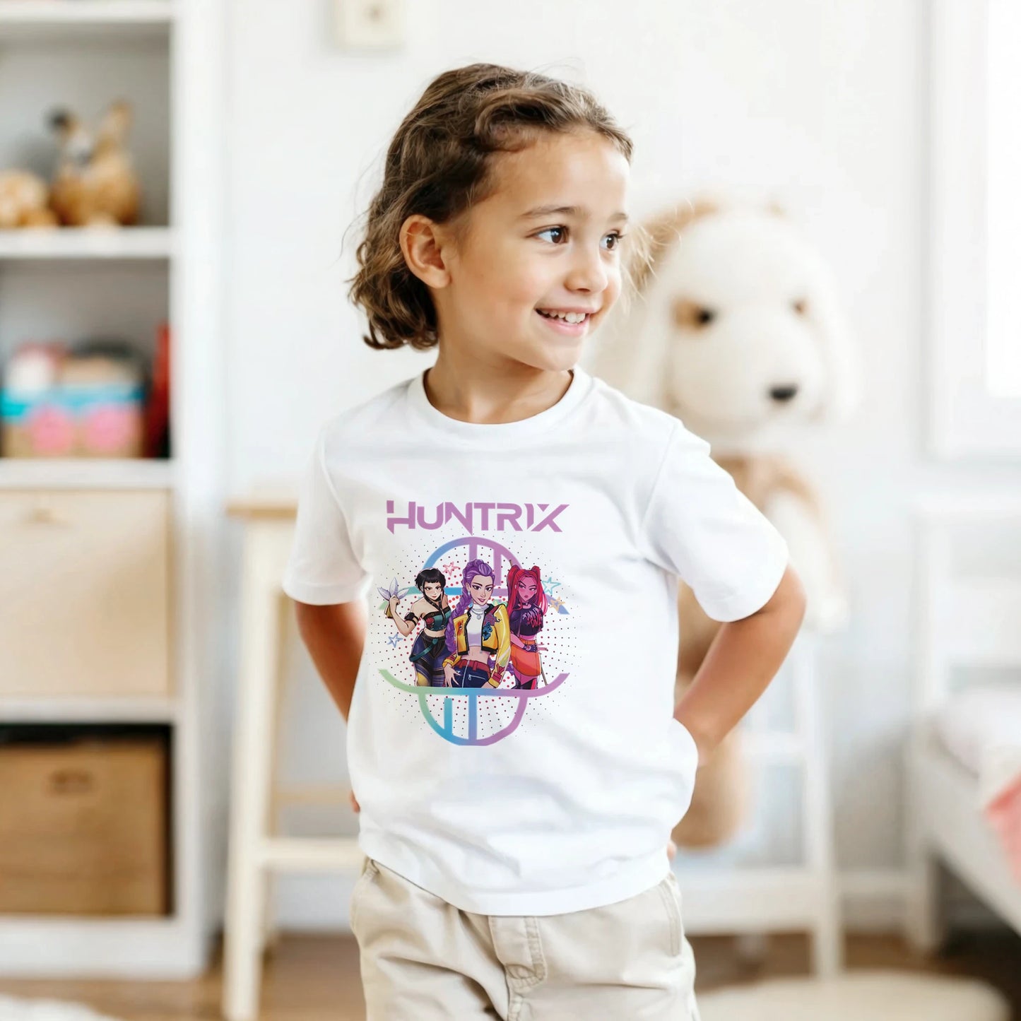 Child wearing a white t-shirt with a colorful graphic design in a room setting