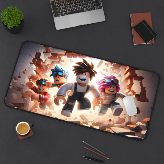 Desk setup with a large mouse pad featuring animated characters, a laptop, phone, and other items on a dark surface.
