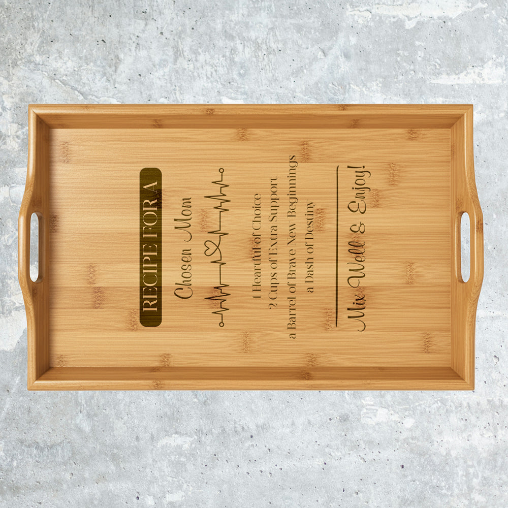 Wooden tray with engraved text on a gray surface