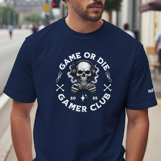 Man wearing a navy blue t-shirt with 'Game or Die Gamer Club' design on a city street.