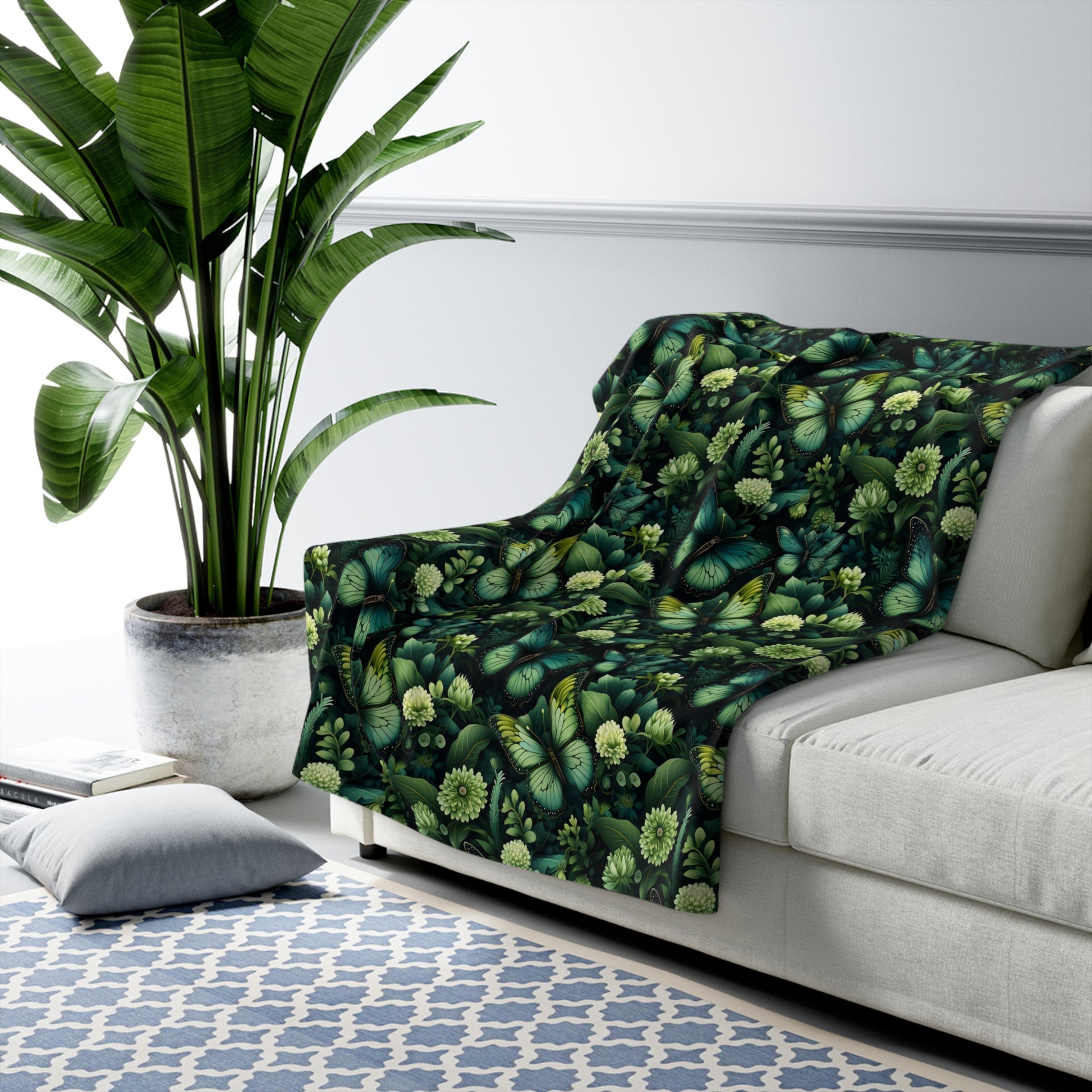 Sherpa blanket on the sofa with green butterflies and flowers design