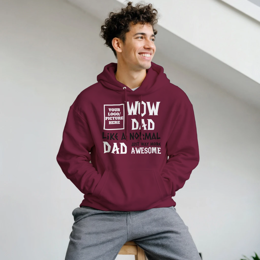 Man wearing a maroon hoodie with text design, sitting indoors.