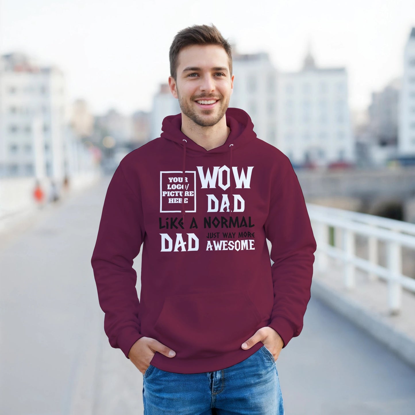 Man wearing a maroon hoodie with text, standing outdoors.