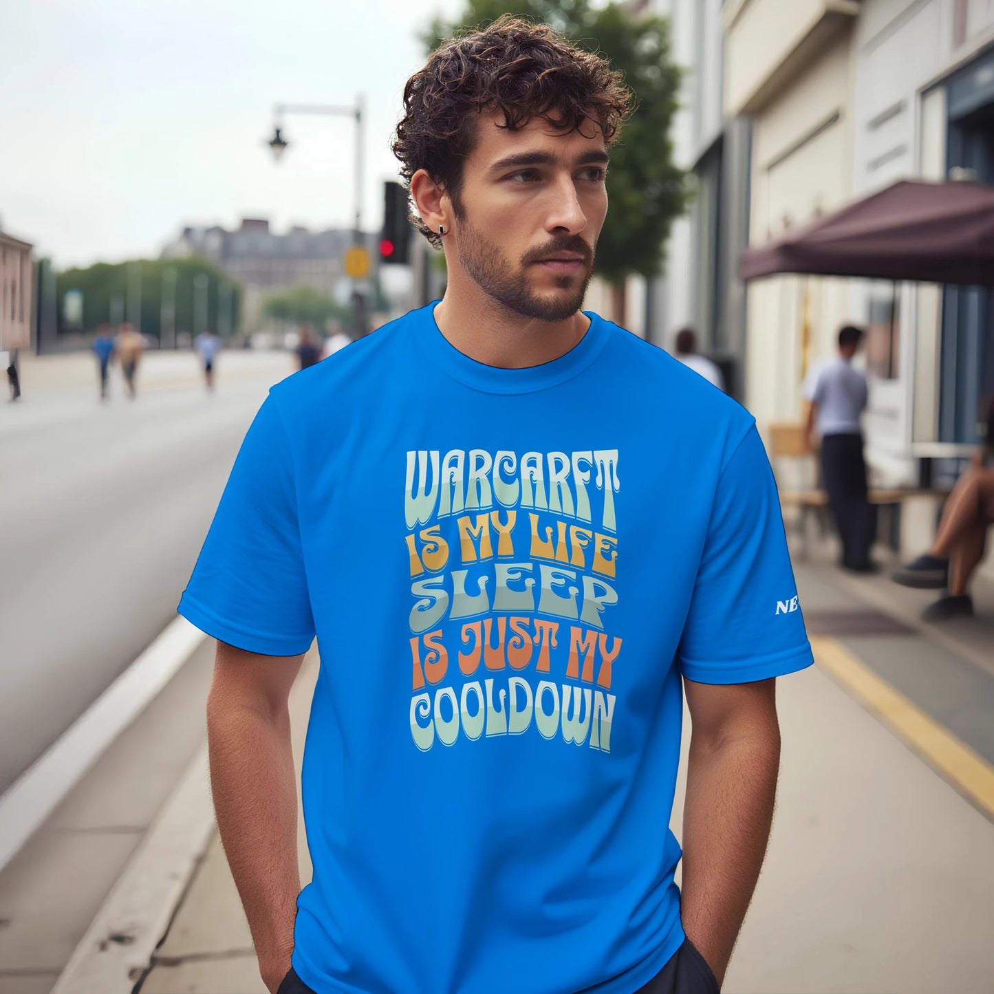 Man wearing a blue t-shirt with text on a city street