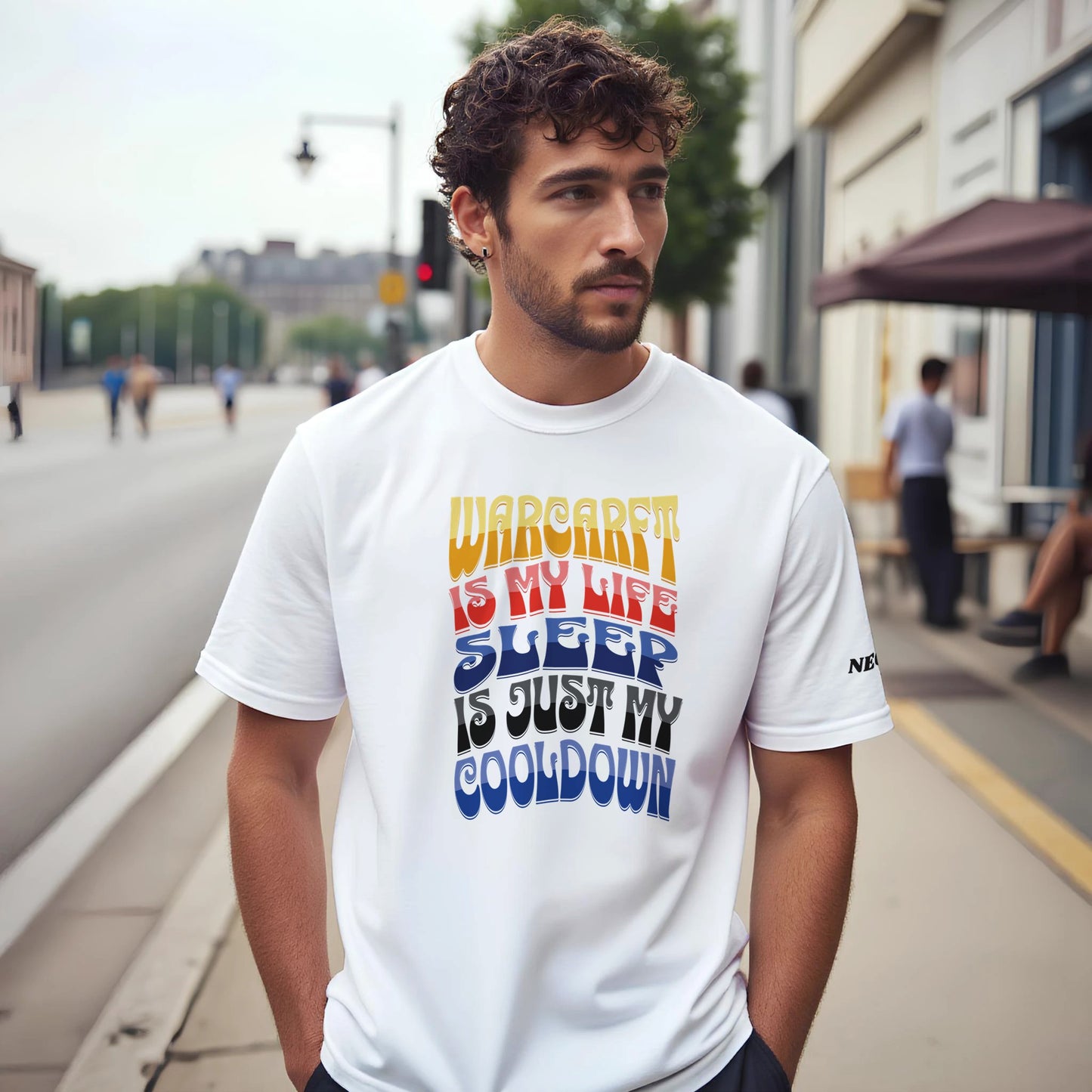Man wearing a white t-shirt with colorful text 'WARCRAFT IS MY LIFE SLEEP IS JUST MY COOLDOWN' on a city street