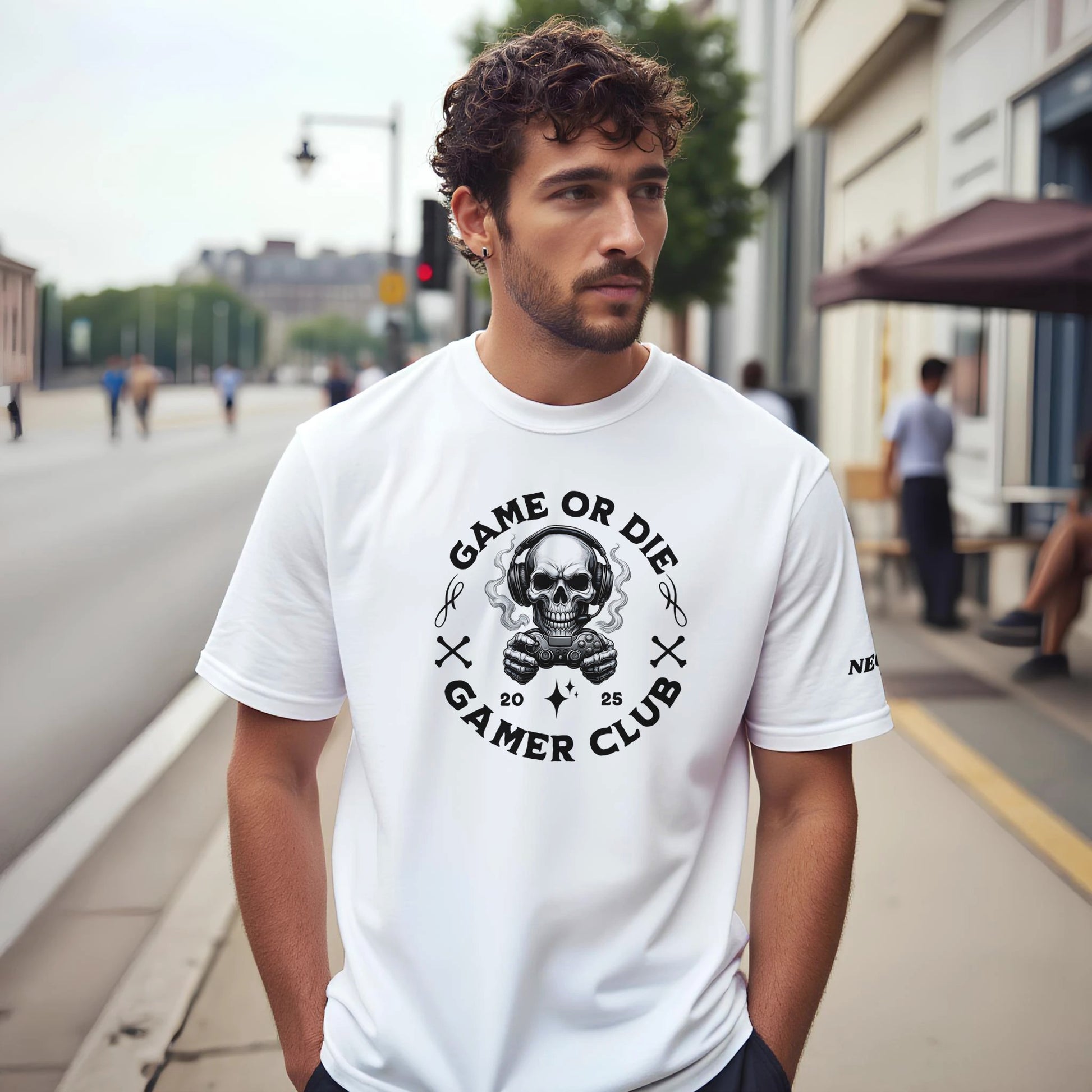 Man wearing a white t-shirt with a graphic design of a skull and text game or die gamer club, on a city street