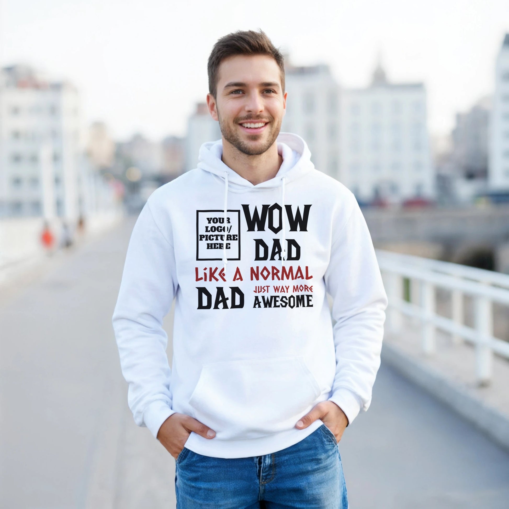 Man wearing a white hoodie with text, standing on a bridge with a cityscape background